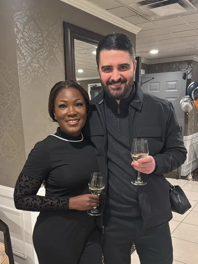 Trish and Trevor raising a glass together